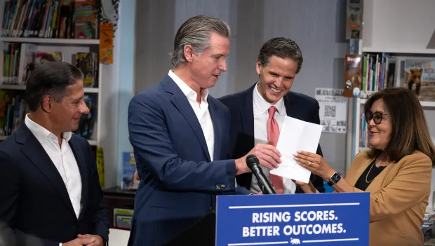 CA Governor Gavin Newsom hands signed Bill AB1454 to Marshall...