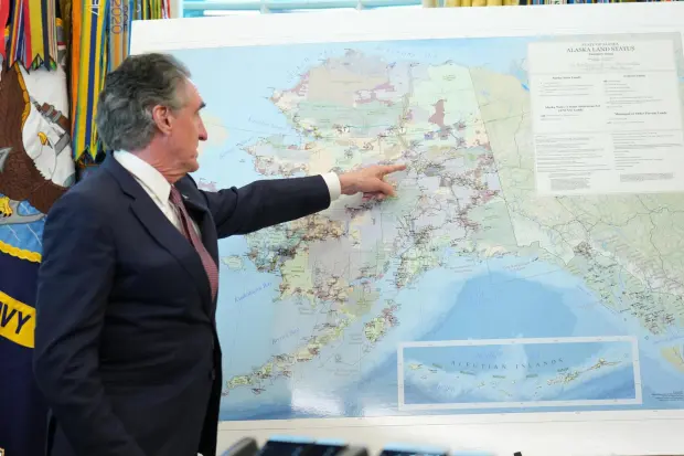 Interior Secretary Doug Burgum points to a map of Alaska as he speaks before President Donald Trump signs an executive order in the Oval Office at the White House, Monday, Oct. 6, 2025, in Washington. (AP Photo/Jacquelyn Martin)