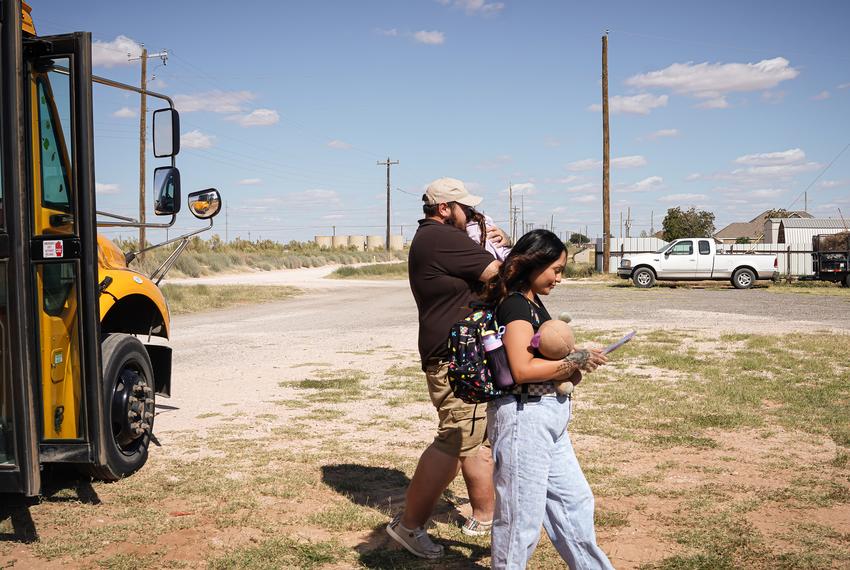 Alfredo and Daniela Santos are carrying their sleeping 4 year old daughter to their home in Midland, Texas on October 6, 2025. They received her from the Midland ISD SPED bus after it drops her off directly to their home. Daniella holds her daughters backpack, her daily stuffed animal of choice, and her book.