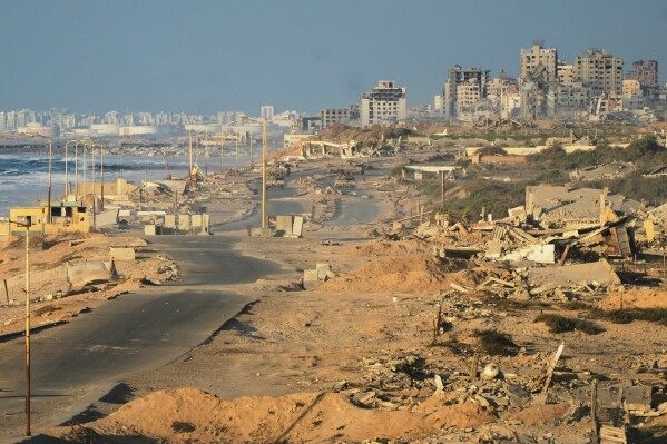Israeli tanks are positioned on the coastal road leading to Gaza City near Wadi Gaza, in the central Gaza Strip, Thursday, Oct. 9, 2025. (AP Photo/Abdel Kareem Hana)