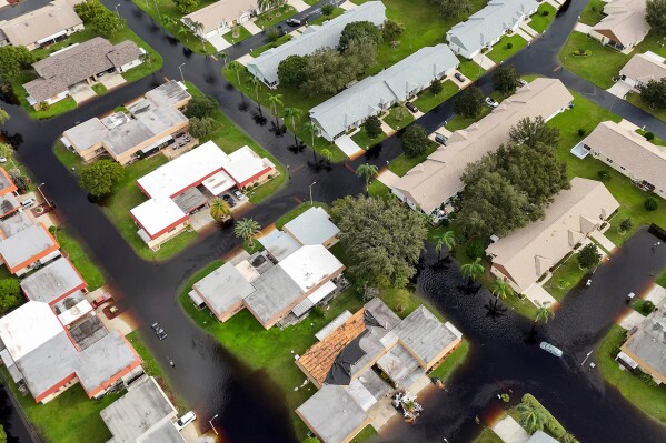 Waters rise in Pasco County neighborhoods as intense rain from Hurricane Milton caused the Anclote River to flood Oct. 11, 2024, in New Port Richey, Fla. (AP Photo/Mike Carlson, File)
