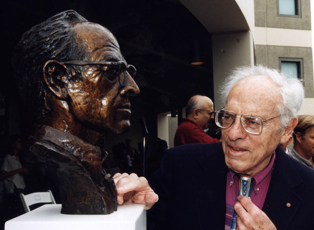 Nobel Laureate Frederick Reines sizes up a bust of himself at UC Irvine in this 1997 file photo. The university honored the distinguished career of the renowned scientist by unveiling the bust and renaming a physical sciences building Frederick Reines Hall. Reines, who came to UCI in 1966, won the Nobel Prize in Physics in 1995 for his research confirming the existence of the neutrino, an abundant but highly elusive subatomic particle. (AP Photo/Paul Kennedy)