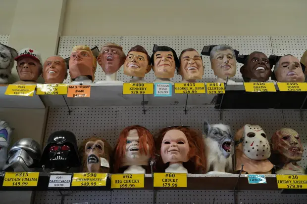 A variety of face masks line the shelves at the House of Humor costume shop in Redwood City, Calif., Thursday, Sept. 18, 2025. (AP Photo/Terry Chea)