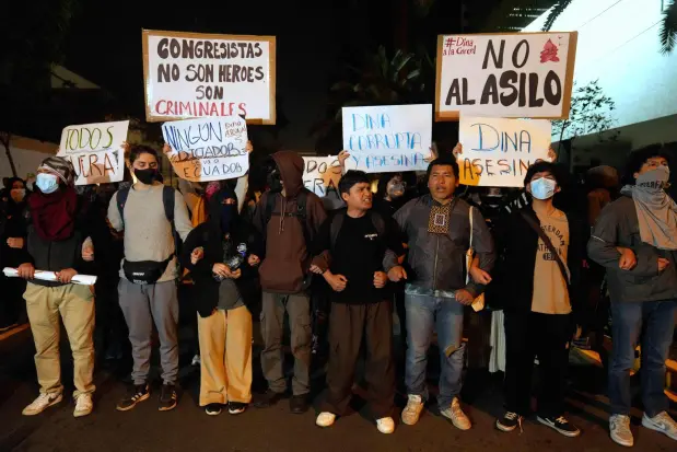Opponents of Peruvian President Dina Boluarte protest outside of the Ecuadorian Embassy in Lima, Peru, Thursday, Oct. 9, 2025. (AP Photo/Martin Mejia)