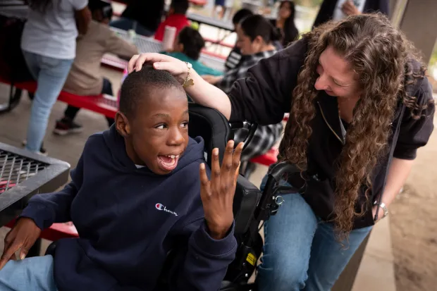 Teacher Arielle Tinero checks on her student, Xavier Young, during...