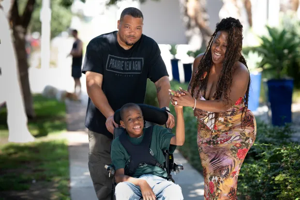 Xavier Young with his parents Isaac Livingston and Courtney Livingston...