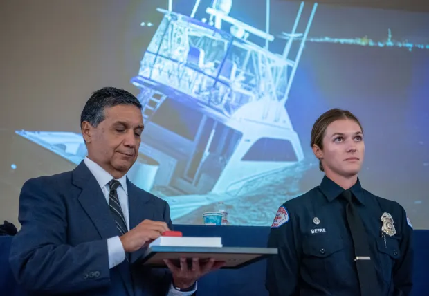 Devon Beebe, a Long Beach Marine Safety Officer, receives a...