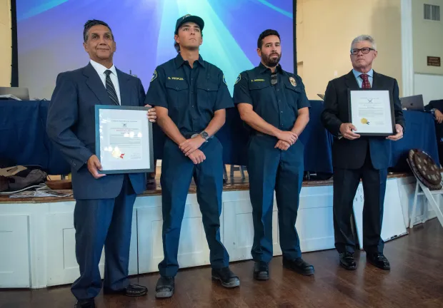 Seal Beach Lifeguards Brett Peoples, center left, and Chris Dominguez...