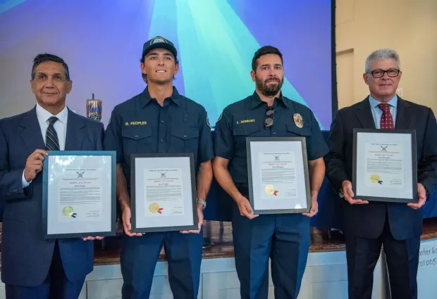 Seal Beach Lifeguards Brett Peoples, center left, and Chris Dominguez...