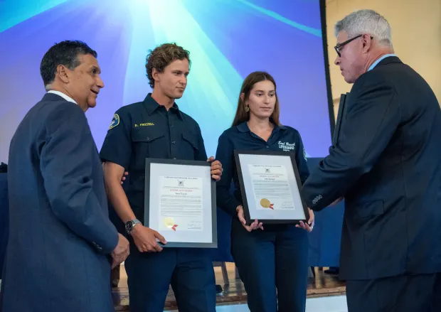 Seal Beach Lifeguards Dean Frizzle, center left, and Ellie Sherlock...