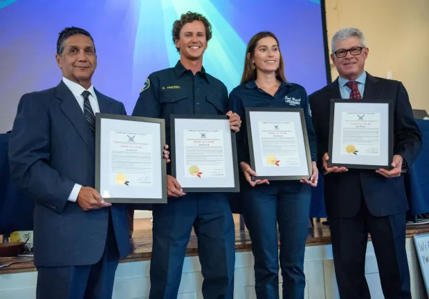 Seal Beach Lifeguards Dean Frizzle, center left, and Ellie Sherlock are presented the Heroic Act Award for their Dec. 22, 2024 rescue of an exhausted swimmer caught in a strong current and large surf, during a California Surf Lifesaving Association ceremony at the Women's Club of Laguna Beach on Thursday, October 9, 2025. (Photo by Jeff Antenore, Contributing Photographer)