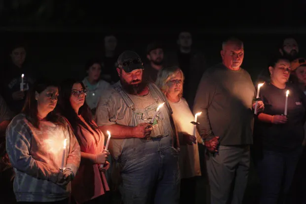Residents attend a vigil honoring the victims of a blast...