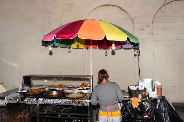 FILE – Street vendor Francisca, an immigrant from Guatemala, prepares...