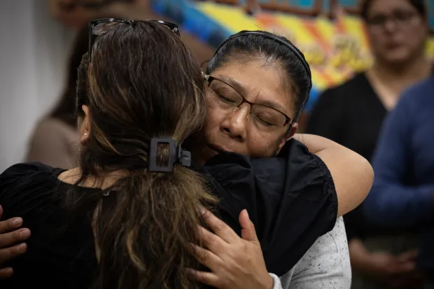 Etelvina Lázaro, right, hugs a fellow parishioner as they say their goodbyes on Wednesday, Oct. 1, 2025 in San Diego, CA. Lázaro made the difficult decision to self deport to Mexico to be with her husband, leaving behind her children and friends. Lázaro's husband Margarito was deported in July. They lived in the United States for over 20 years. (Ana Ramirez / The San Diego Union-Tribune)
