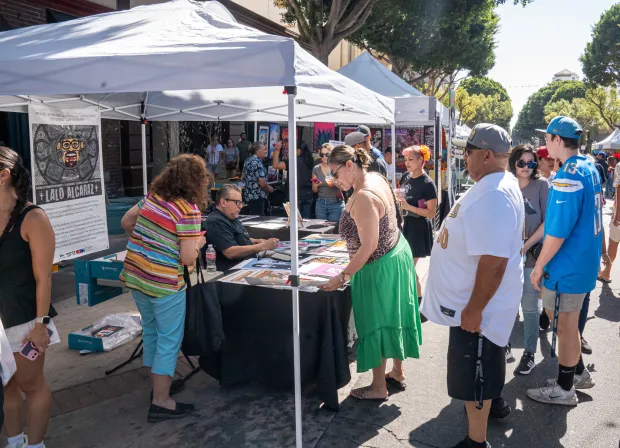 The crowd around Lalo Alcaraz’s booth during the Casita Del...