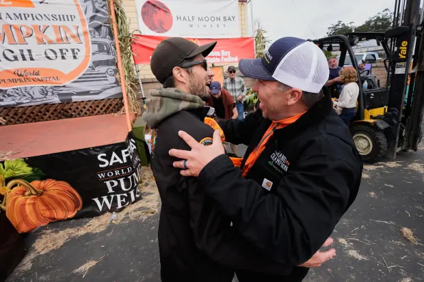 Brandon Dawson, left, is congratulated by Travis Gienger, who was...