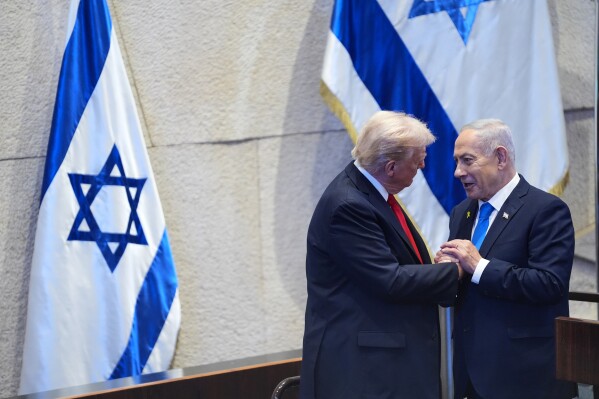 President Donald Trump talks with Israel's Prime Minister Benjamin Netanyahu at the Knesset, Israel's parliament, Monday, Oct. 13, 2025, in Jerusalem. (AP Photo/Evan Vucci, Pool)