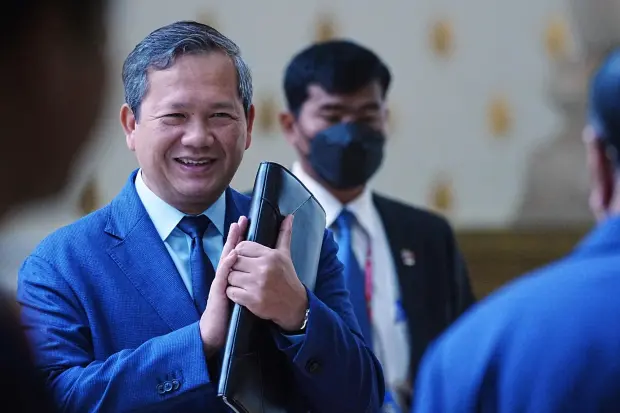 FILE - Cambodian Prime Minister Hun Manet, left, greets lawmakers as he arrives at the session on the draft law on amending the law on nationality at the National Assembly in Phnom Penh Cambodia, Monday, Aug. 25, 2025. (AP Photo/Heng Sinith, File)