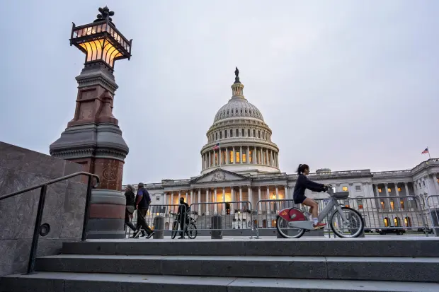 The Capitol is seen at dusk as Democrats and Republicans...
