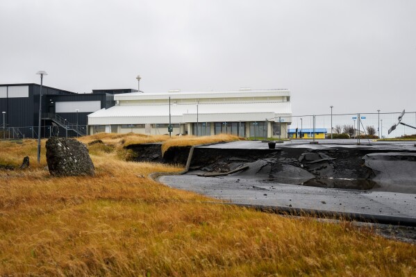 Cracks are visible near the sports center from a 2023 volcanic eruption in Grindavik, Iceland, Oct. 13, 2025. (AP Photo/Marco di Marco)