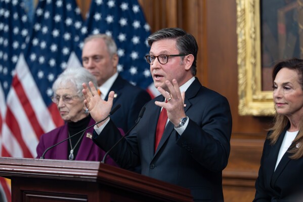 Speaker of the House Mike Johnson, R-La., flanked by Rep. Virginia Foxx, R-N.C., chair of the House Rules Committee, left, and Rep. Lisa McClain, R-Mich., tells reporters he is starting a project along with the speaker of the Israeli Knesset to rally global leaders to support President Donald Trump's nomination for next year's Nobel Peace Prize, as the government shutdown enters its third week, at the Capitol in Washington, Tuesday, Oct. 14, 2025. (AP Photo/J. Scott Applewhite)