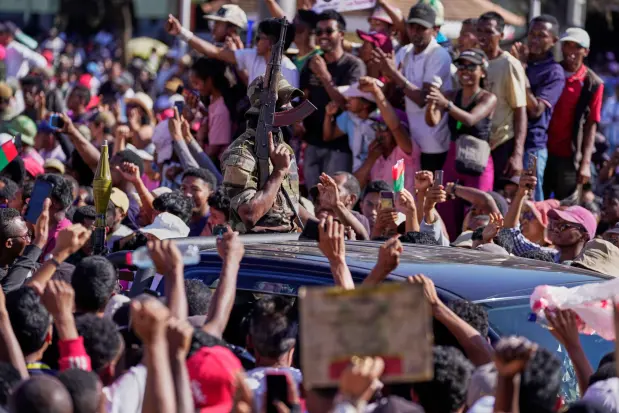Members of the CAPSAT military unit are cheered by protesters as they arrive to address a crowd, announcing plans to take over the government and dissolve the Senate and the electoral commission (CENI) in Antananarivo, Madagascar, Tuesday, Oct. 14, 2025. (AP Photo/Brian Inganga)