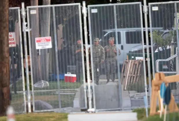 Members of the Texas National Guard stand outside the Immigration and Customs Enforcement (ICE) processing facility in Broadview, Ill. on Thursday, Oct. 9, 2025. (AP Photo/Talia Sprague)