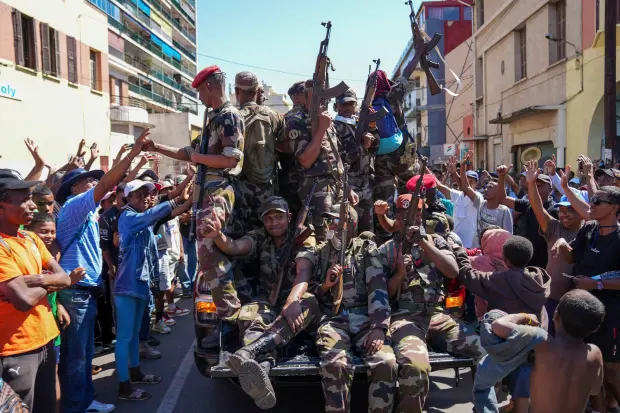 Soldiers are greeted by people gathering for a ceremony in...