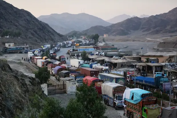 A line of cargo trucks bound for Pakistan is stranded...