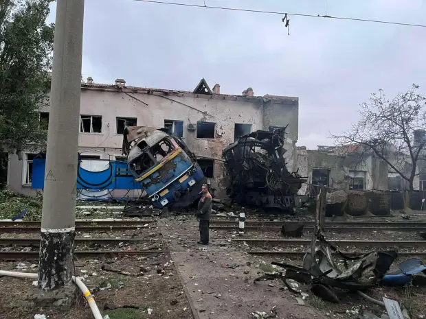 In this photo provided by Office of the Deputy Prime Minister for Restoration and Development on Thursday, Oct. 2, 2025, a railway worker stands in front of a train locomotive destroyed by a Russian strike in Odesa, Ukraine. (Office of the Deputy Prime Minister for Restoration and Development via AP)