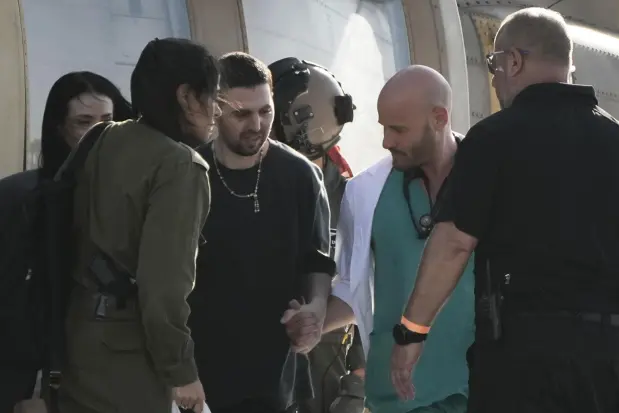 Elkana Bohbot, an Israeli hostage released from the Gaza Strip waves walks off a helicopter at the Sheba Medical Center in Ramat Gan, Israel, Monday, Oct. 13, 2025. (AP Photo/Leo Correa)