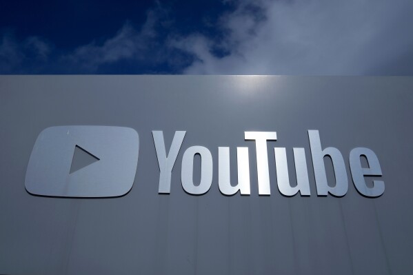A YouTube sign is shown near the company's headquarters in San Bruno, Calif., Wednesday, March 12, 2025. (AP Photo/Jeff Chiu, file)