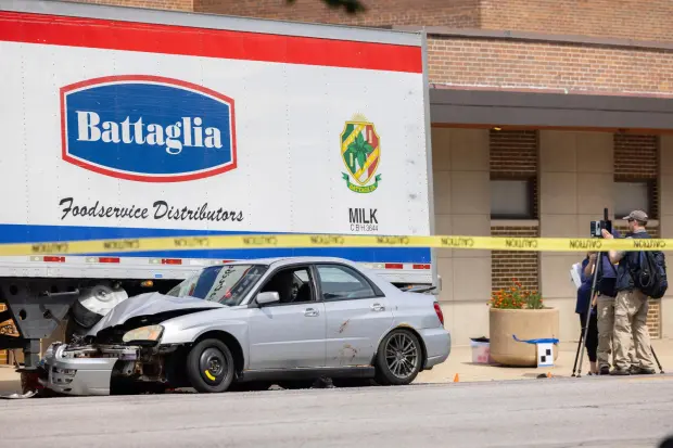 Law enforcement personnel investigate after the Department of Homeland Security said an Immigration and Customs Enforcement agent fatally shot a man in the Franklin Park suburb of Chicago on Friday, Sept. 12, 2025. (Candace Dane Chambers/Chicago Sun-Times via AP)